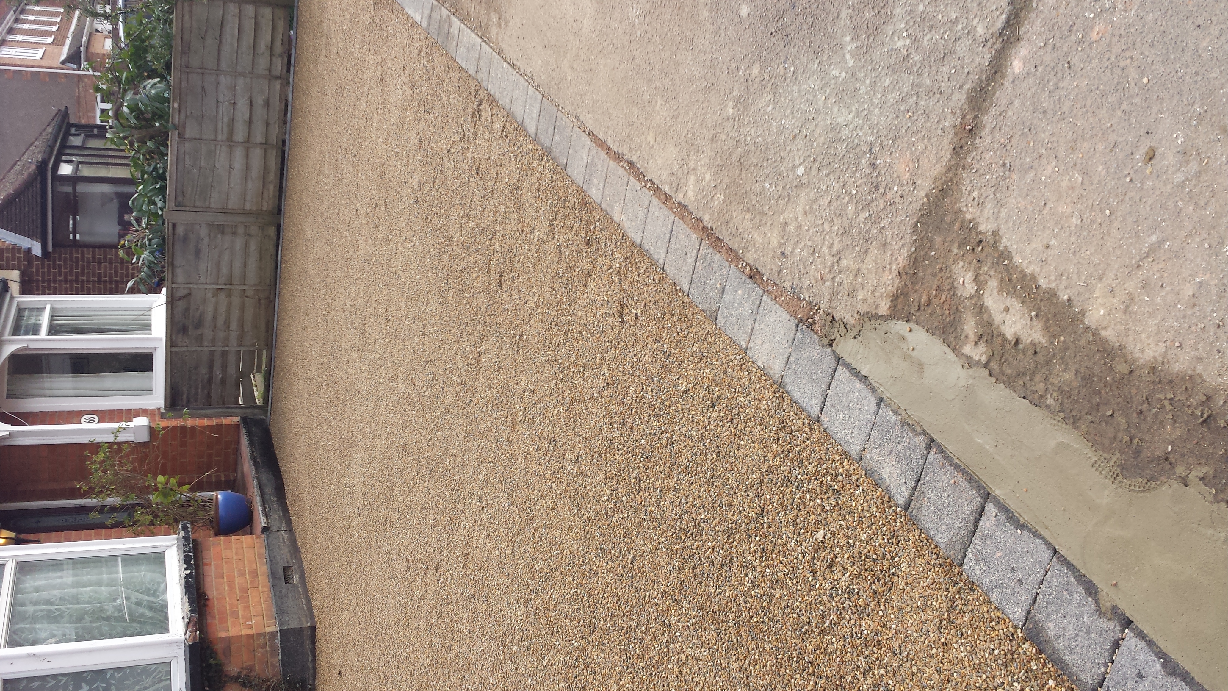 Driveway after tar and chip, fresh stone-dressed finish