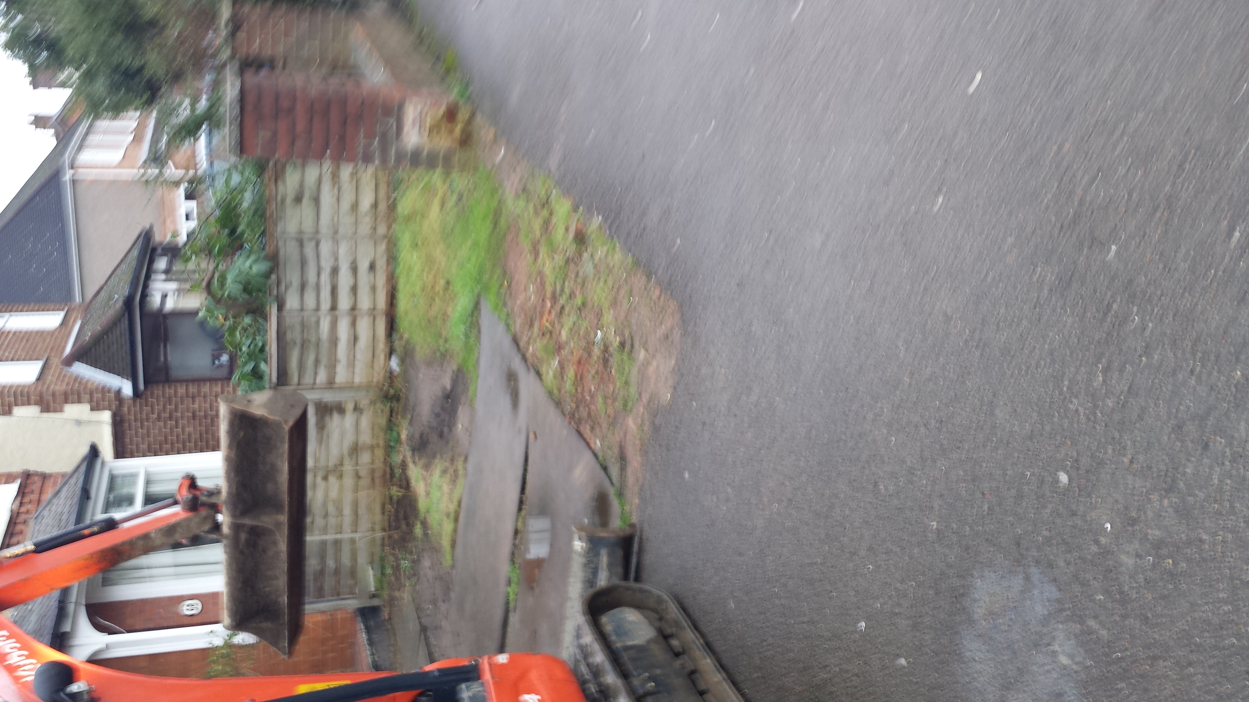 Driveway before tar and chip, worn and patchy surface